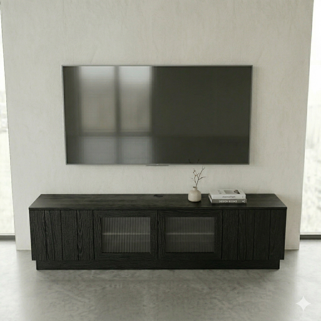 Black entertainment console with a TV above it in a minimalistic room.