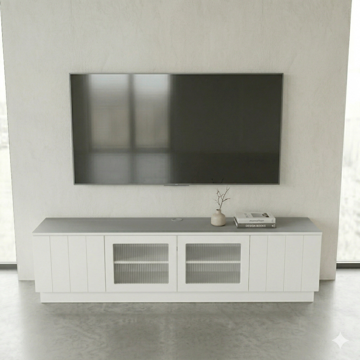Modern living room with a flat-screen TV mounted on the wall above a white entertainment console.
